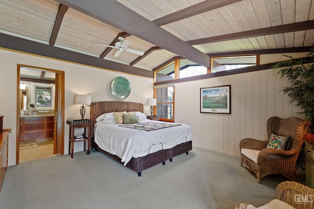 carpeted bedroom featuring lofted ceiling with beams, wood ceiling, a ceiling fan, and ensuite bathroom