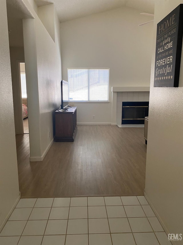 6208 Stonegate Dr, Bakersfield, CA 93306 - unfurnished living room featuring wood finished floors, a fireplace, and vaulted ceiling