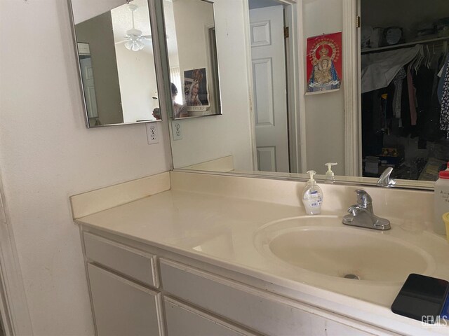 6208 Stonegate Dr, Bakersfield, CA 93306 - bathroom featuring vanity, ceiling fan, and a spacious closet