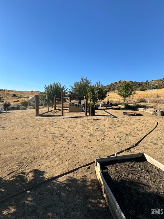 view of yard featuring a mountain view and a rural view