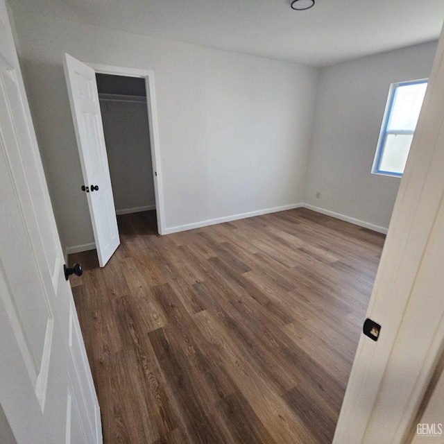 145 T St, Bakersfield, CA 93304 - unfurnished bedroom with dark wood-style flooring and baseboards