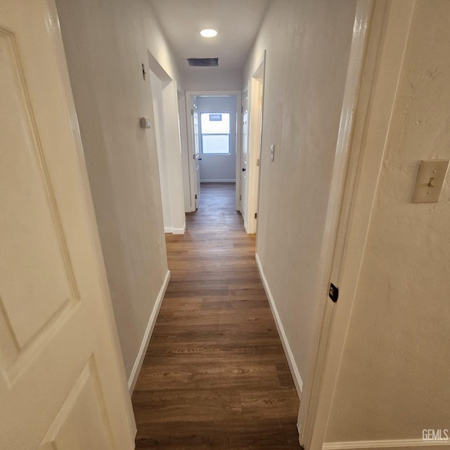 145 T St, Bakersfield, CA 93304 - corridor featuring dark wood-style floors, visible vents, and baseboards