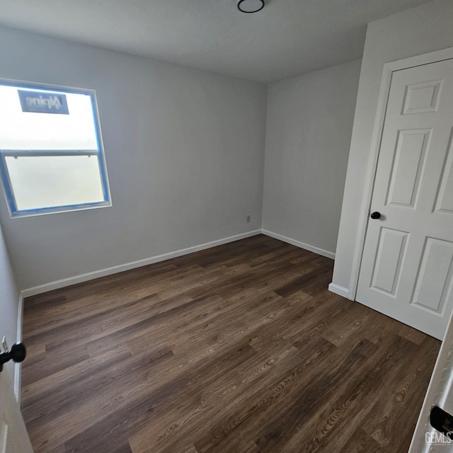 145 T St, Bakersfield, CA 93304 - unfurnished bedroom with dark wood-style floors and baseboards