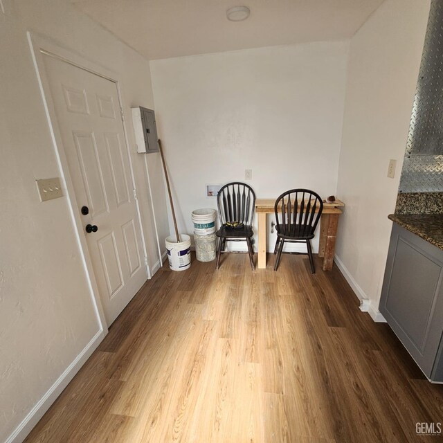 145 T St, Bakersfield, CA 93304 - unfurnished room with electric panel, baseboards, and dark wood-type flooring