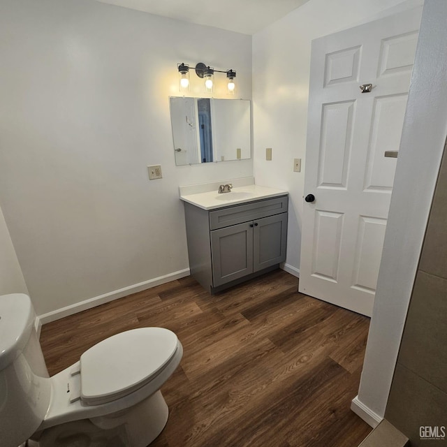 145 T St, Bakersfield, CA 93304 - bathroom with toilet, baseboards, wood finished floors, and vanity