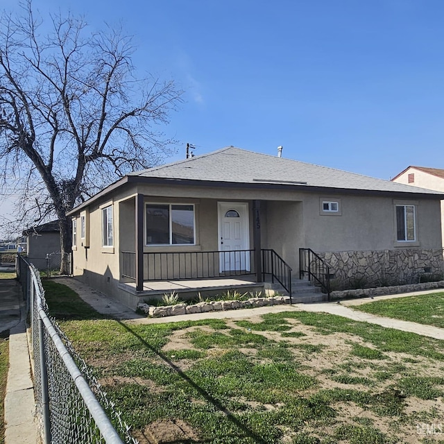 145 T St, Bakersfield, CA 93304 - view of front of home with fence, roof with shingles, crawl space, stucco siding, and a front lawn