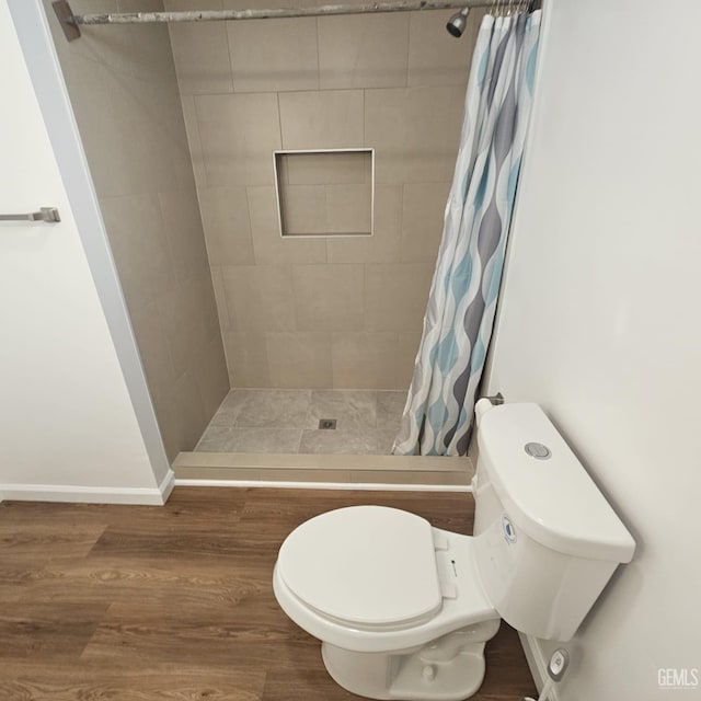 145 T St, Bakersfield, CA 93304 - bathroom with a stall shower, wood finished floors, and toilet