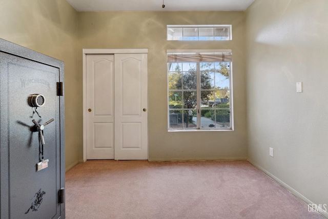 unfurnished bedroom featuring a closet, carpet, and baseboards