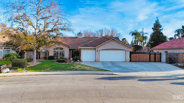 view of front of house featuring a chimney, a tiled roof, an attached garage, fence, and a front lawn