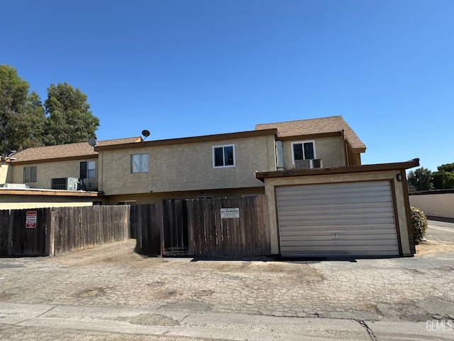 5001 Belle Ter Unit 12, Bakersfield, CA 93309 - view of front facade with stucco siding and an attached garage