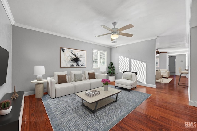 living room featuring dark hardwood / wood-style floors, ceiling fan, and ornamental molding