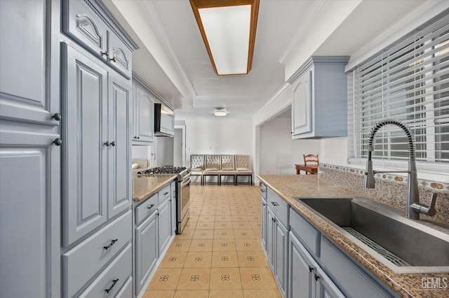 kitchen featuring stainless steel range with gas cooktop, crown molding, sink, gray cabinets, and stone countertops