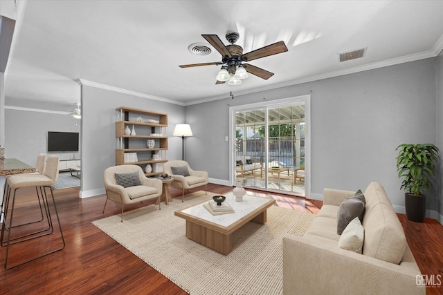 living room featuring hardwood / wood-style floors, ceiling fan, and crown molding