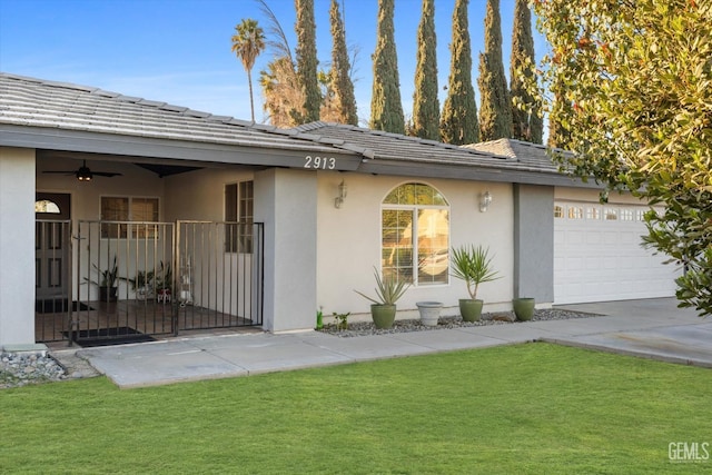 view of front of house featuring a garage and a front lawn