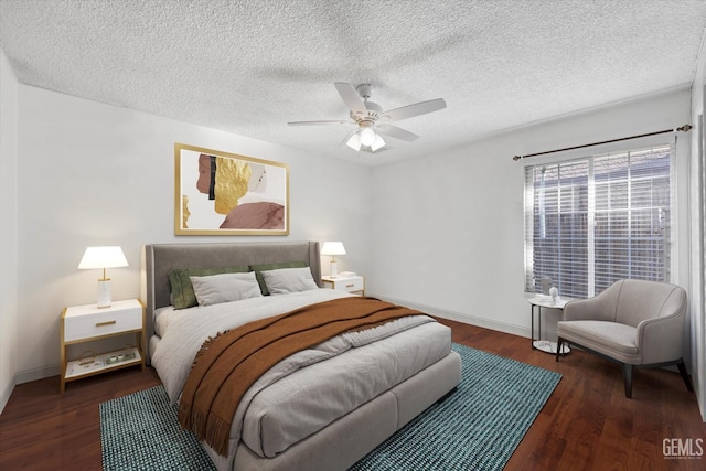 bedroom with ceiling fan, dark hardwood / wood-style flooring, and a textured ceiling