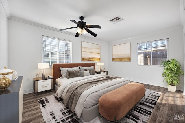 bedroom with multiple windows, dark hardwood / wood-style floors, ceiling fan, and ornamental molding