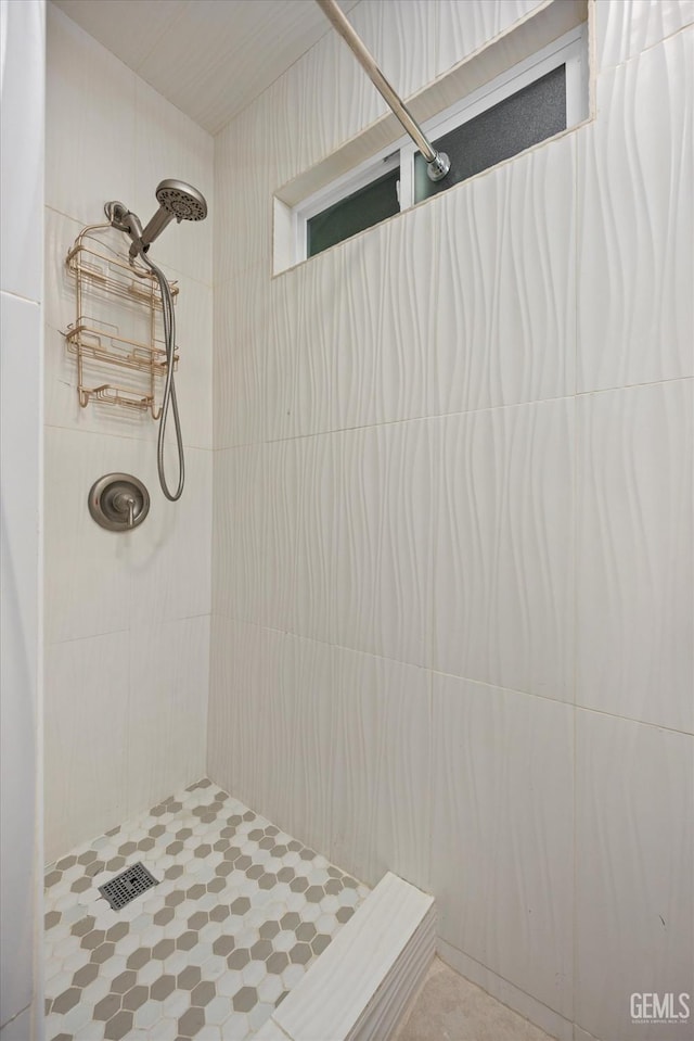 bathroom with tiled shower