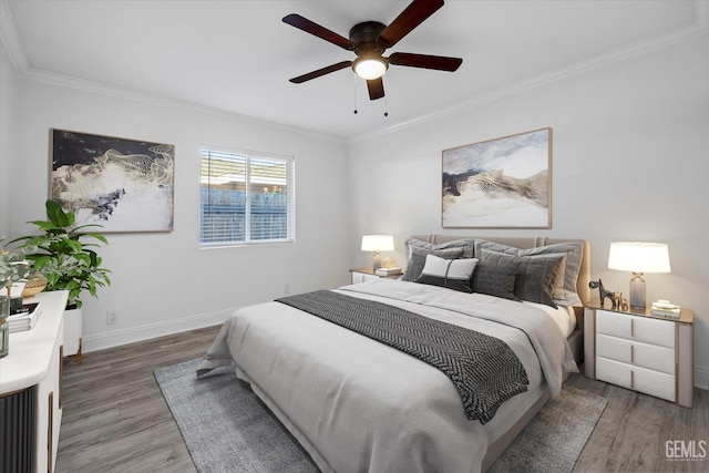 bedroom featuring ceiling fan, dark hardwood / wood-style flooring, and crown molding