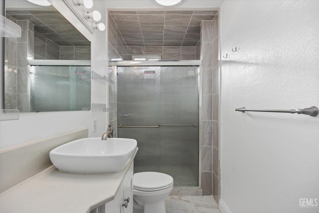 bathroom featuring vanity, toilet, and walk in shower