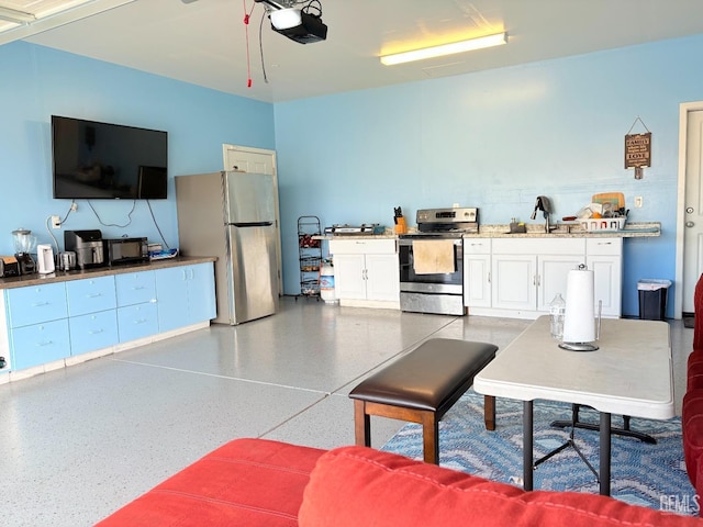 kitchen with stainless steel appliances, white cabinetry, and sink