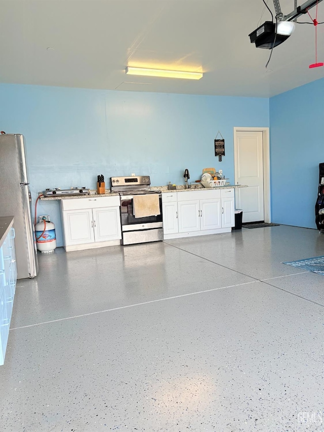 garage featuring stainless steel fridge and a garage door opener