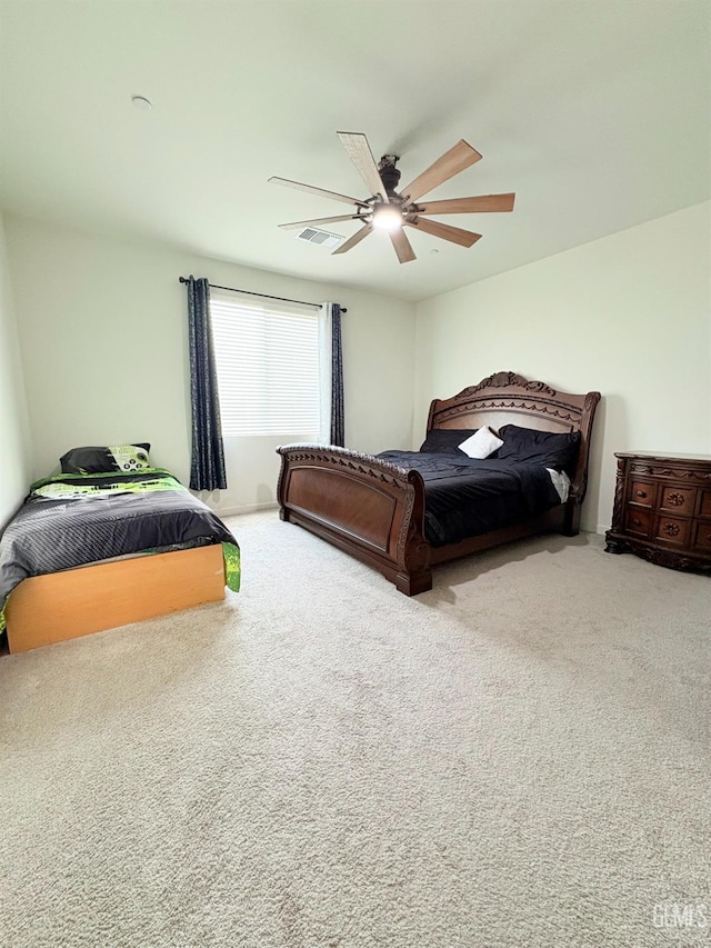 bedroom featuring ceiling fan and carpet