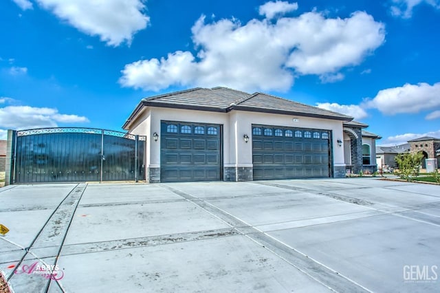 garage featuring driveway and a gate