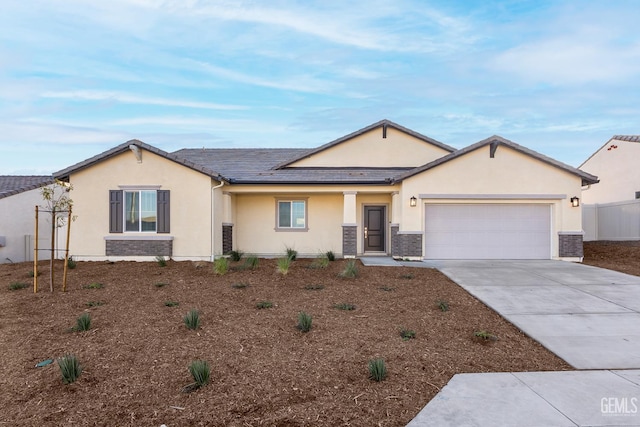5111 Beaverhead Ave, Bakersfield, CA 93306 - view of front facade with stucco siding, concrete driveway, and a garage