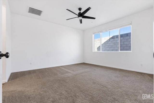 carpeted spare room featuring ceiling fan