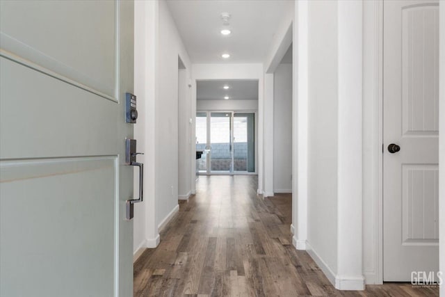 hallway with wood-type flooring