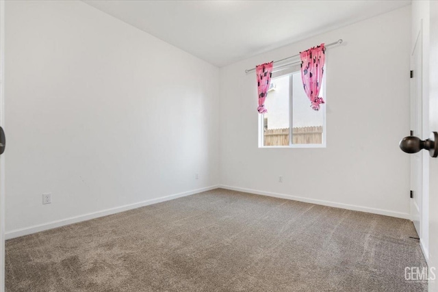 carpeted empty room featuring lofted ceiling