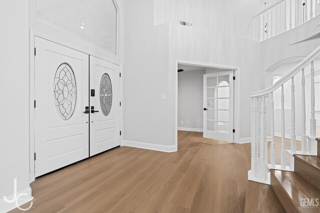 11009 Bright Water Way, Bakersfield, CA 93311 - foyer featuring wood finished floors, stairway, baseboards, and a towering ceiling