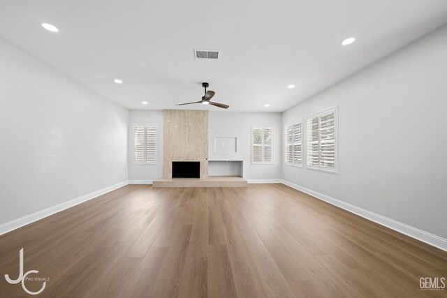 11009 Bright Water Way, Bakersfield, CA 93311 - unfurnished living room with wood finished floors, a fireplace, baseboards, ceiling fan, and recessed lighting