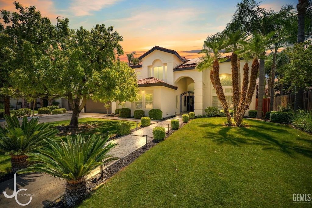 11009 Bright Water Way, Bakersfield, CA 93311 - mediterranean / spanish house with a tiled roof, solar panels, stucco siding, concrete driveway, and an attached garage