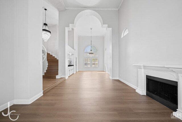 11009 Bright Water Way, Bakersfield, CA 93311 - entrance foyer featuring ornamental molding, a chandelier, wood finished floors, a fireplace, and baseboards