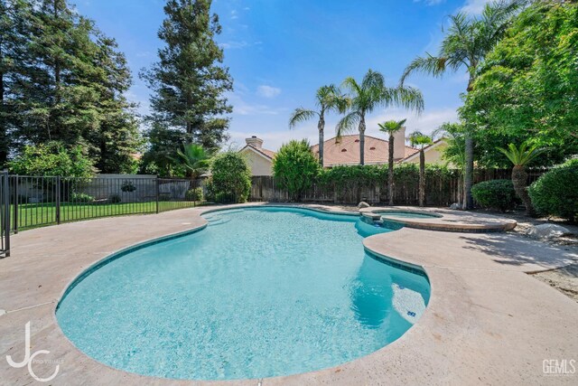 11009 Bright Water Way, Bakersfield, CA 93311 - view of pool featuring a fenced backyard, a patio, and a pool with connected hot tub