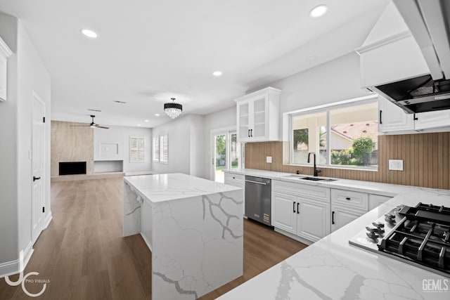 11009 Bright Water Way, Bakersfield, CA 93311 - kitchen with appliances with stainless steel finishes, a sink, a center island, recessed lighting, and light stone counters