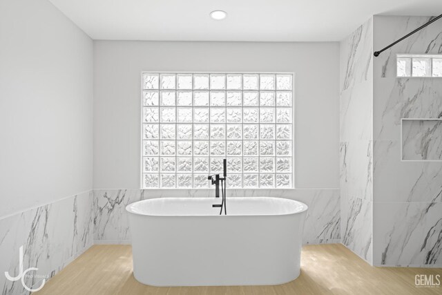 11009 Bright Water Way, Bakersfield, CA 93311 - full bath featuring tile walls, a freestanding bath, wood finished floors, recessed lighting, and a wainscoted wall