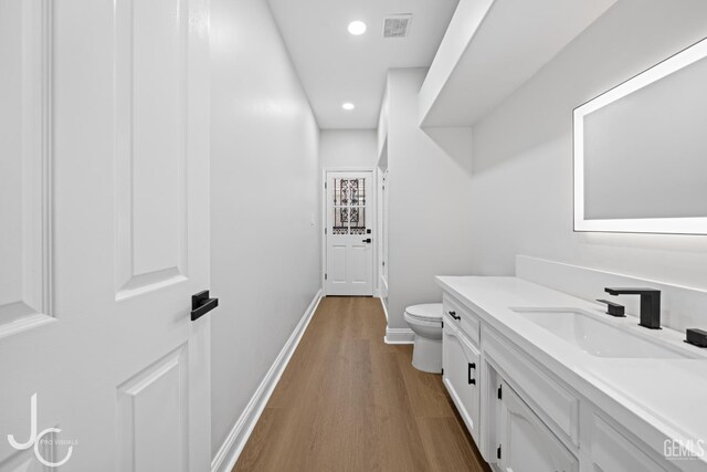 11009 Bright Water Way, Bakersfield, CA 93311 - bathroom with toilet, vanity, wood finished floors, recessed lighting, and baseboards