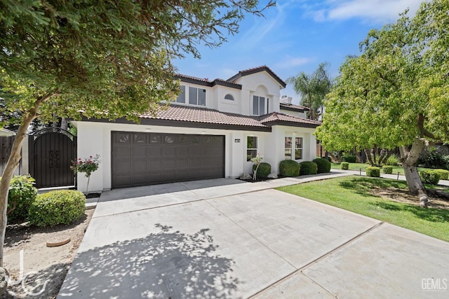 11009 Bright Water Way, Bakersfield, CA 93311 - mediterranean / spanish-style home with driveway, stucco siding, a tile roof, a gate, and an attached garage