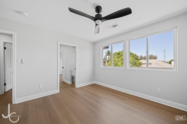11009 Bright Water Way, Bakersfield, CA 93311 - unfurnished bedroom featuring baseboards, wood finished floors, ceiling fan, and connected bathroom