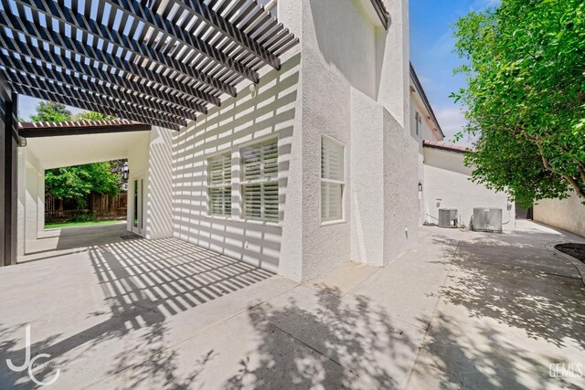 11009 Bright Water Way, Bakersfield, CA 93311 - view of side of property with stucco siding, a patio area, and a pergola