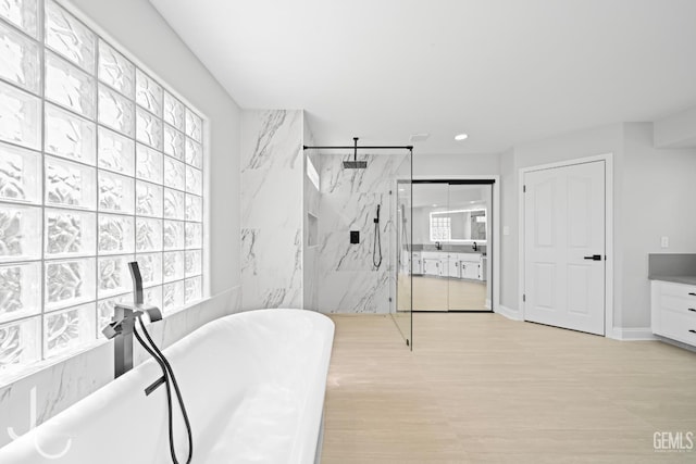 11009 Bright Water Way, Bakersfield, CA 93311 - bathroom with healthy amount of natural light, a marble finish shower, vanity, wood finished floors, and recessed lighting