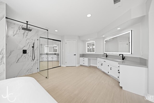 11009 Bright Water Way, Bakersfield, CA 93311 - full bath with a marble finish shower, vanity, recessed lighting, a freestanding tub, and wood finished floors