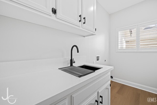 11009 Bright Water Way, Bakersfield, CA 93311 - laundry room with hookup for a washing machine, cabinet space, hookup for an electric dryer, dark wood-style flooring, and baseboards