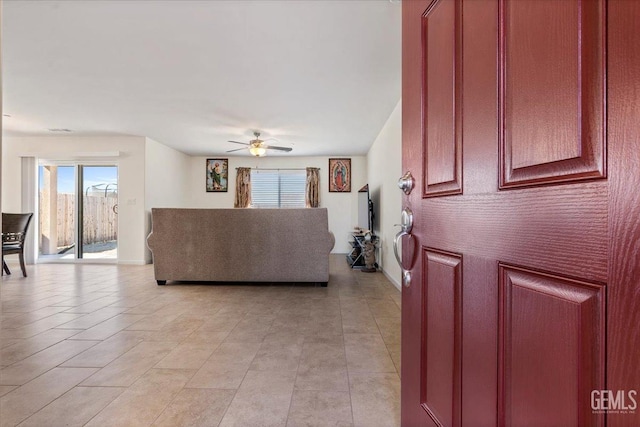 living room with ceiling fan and light tile patterned floors