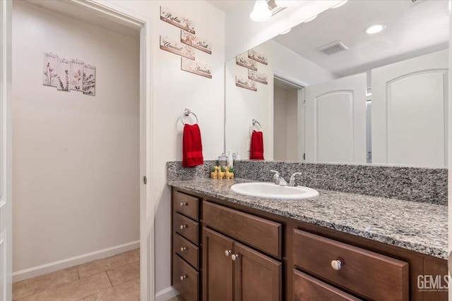 bathroom with tile patterned flooring and vanity