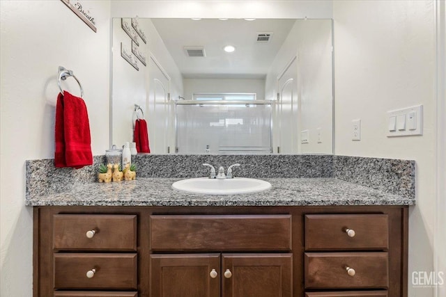 bathroom with vanity and walk in shower