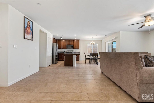 living room featuring ceiling fan with notable chandelier