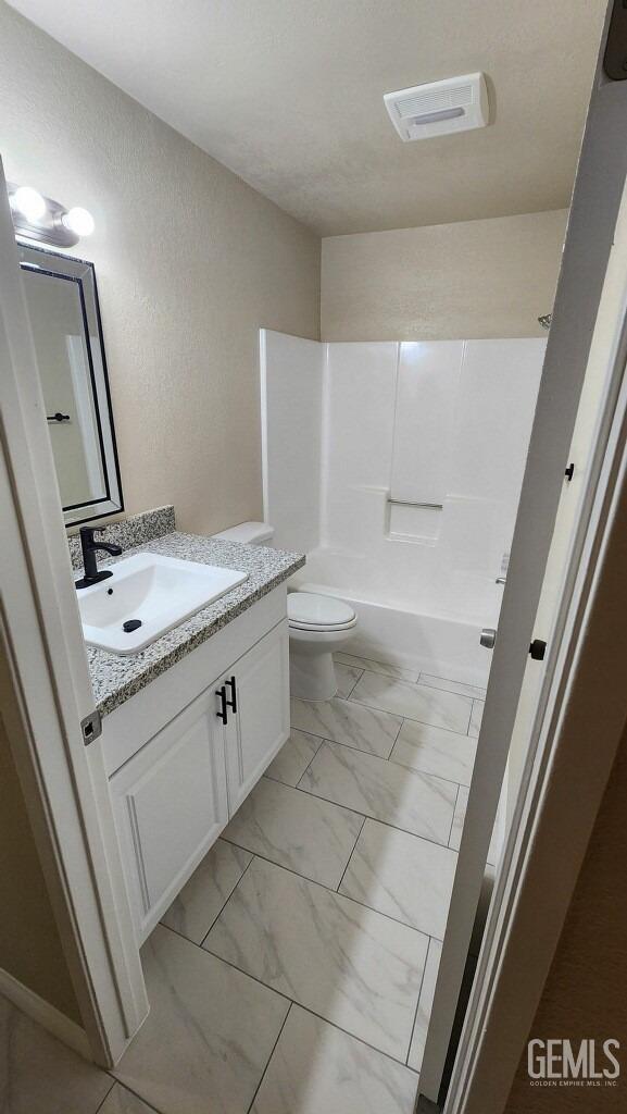 full bathroom featuring vanity, toilet, and shower / bathing tub combination